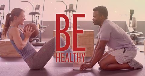 Diverse Duo Exercising in Modern Gym Setting
