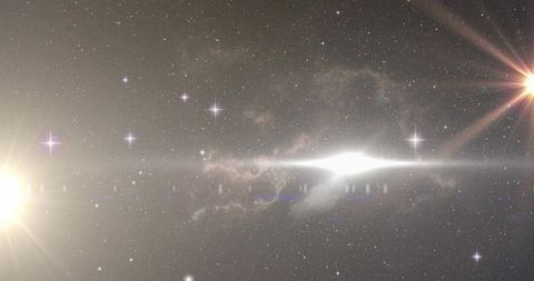 Elongated nebula glowing across cosmic starfield with radiant core and lens-flare stars
