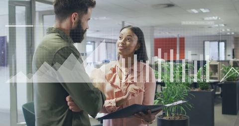 Coworkers Discussing Data with Overlay Charts in Modern Office