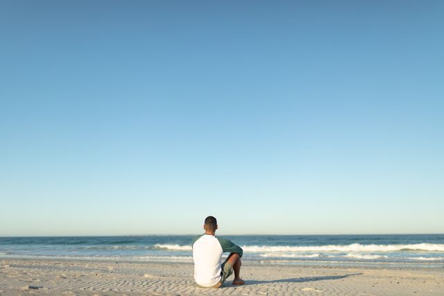 Rear view of man relaxing on the beach