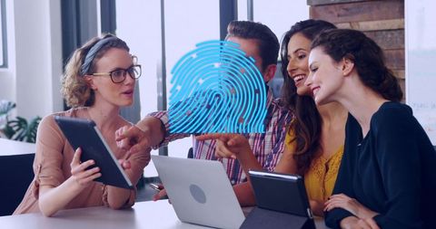 Modern office team collaborating on biometric security with tablets and fingerprint overlay