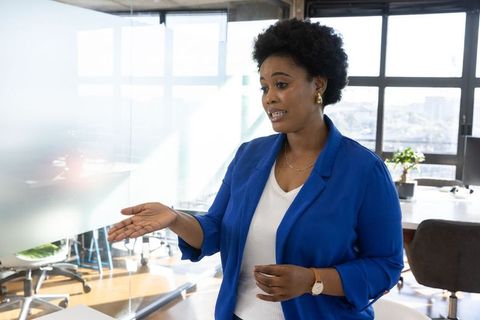 Confident Professional Woman Discussing Business in Modern Office