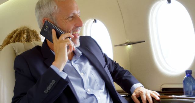 Confident Businessman Making Phone Call on Private Jet - Download Free Stock Images Pikwizard.com