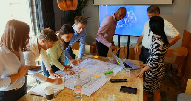 Multicultural Team Collaborating on Architectural Design Project in Modern Office - Download Free Stock Images Pikwizard.com