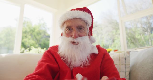 Senior Man in Santa Claus Outfit Sitting at Home - Download Free Stock Images Pikwizard.com