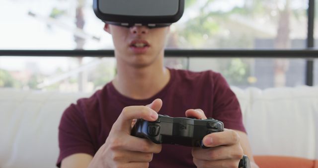 Asian boy wearing vr headset playing image games at home. teenager lifestyle and living concept