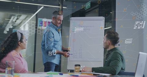 Team Analyzing Development Charts During Corporate Meeting