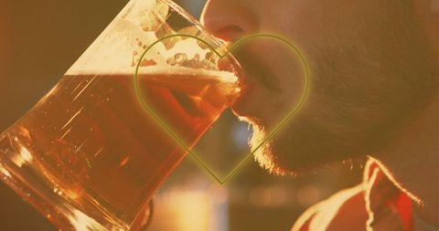Man Enjoying Beer With Neon Heart Overlay