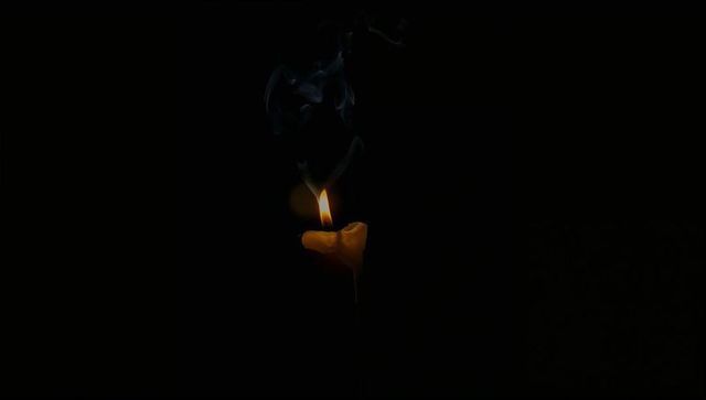 Heart-Shaped Candle Flickering in Dark Room with Smoky Aura