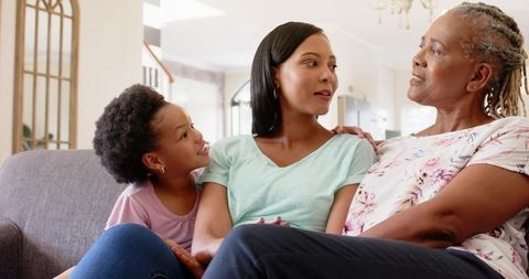 Three Generations of Women Bonding in Cozy Living Room