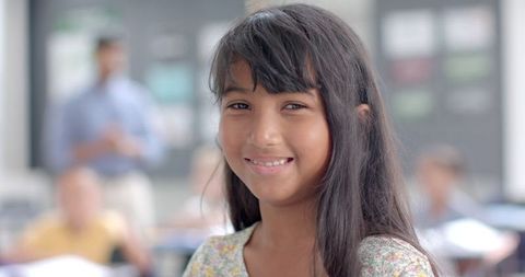 Confident Biracial Girl Smiling in Classroom