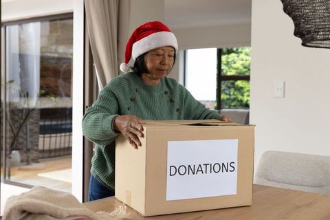 Senior Woman Celebrating Christmas with Seasonal Charity