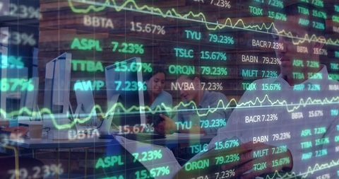 Business professionals analyzing complex financial data displayed on computer screens. Useful for illustrating themes of collaboration, technology in finance, and market analysis. Ideal for articles or presentations on financial planning, stock market trends, and data-driven decision making.