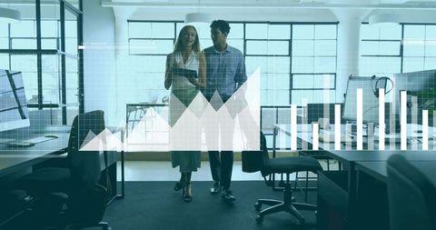 Walking colleagues navigating open office with tablet and data analytics dashboard overlay