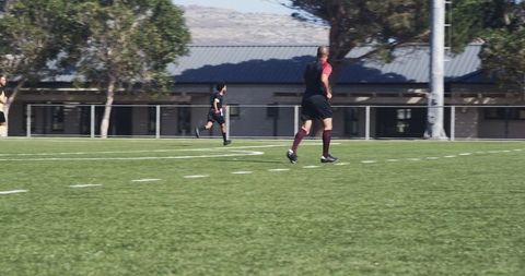 Athletes Warming Up on Soccer Field Under Clear Sky