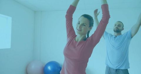 Woman stretching in home gym with exercise ball