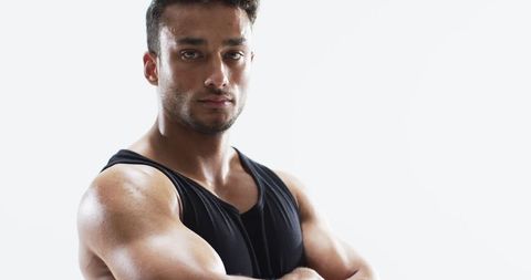 Confident Young Athlete Showing Strength in Gym - Download Free Stock Images Pikwizard.com