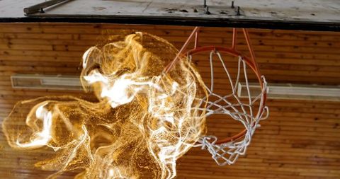 Dynamic Fire Swirl Engulfing Basketball Hoop in Gymnasium