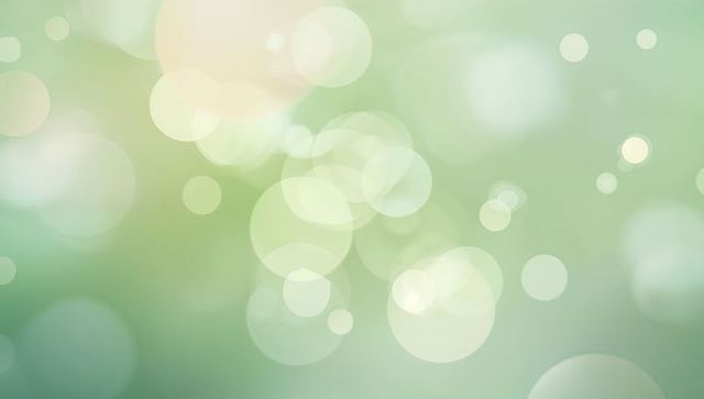 Glowing bokeh circles drifting on soft mint green and pale yellow gradient background