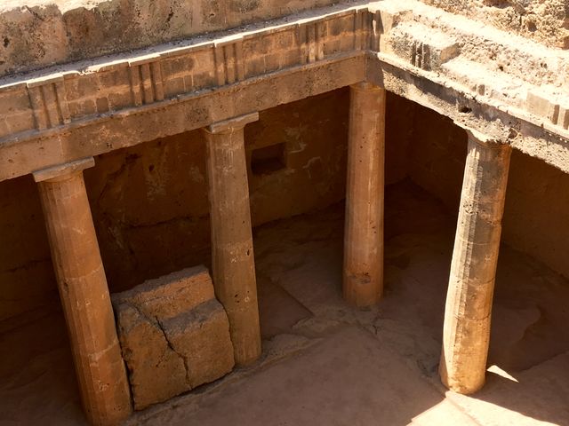 This image shows an ancient Greek underground tomb featuring stone columns. It captures the architectural style and historical significance of the structure, which can be used for educational purposes, travel and tourism promotions, or archaeological research publications. The photo highlights the textures and weathering patterns of the stonework, offering a glimpse into ancient construction techniques and preservation.