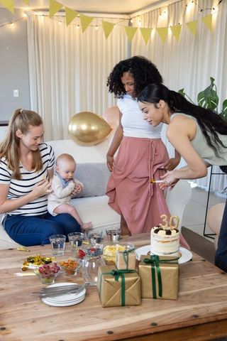 Diverse Friends Celebrating 30th Birthday with Baby and Cake