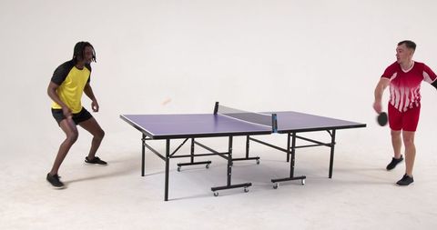Diverse friends enjoy intense ping pong match