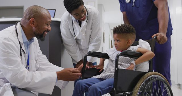 Diverse doctors talking to child patient sitting in wheelchair at hospital - Download Free Stock Photos Pikwizard.com