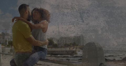 Urban seafront romance: couple embracing on metal railing by waterfront promenade