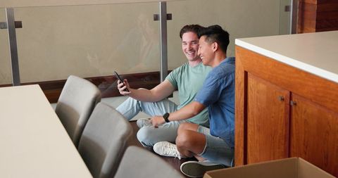 Diverse Gay Couple Smiling and Taking Selfie at Home