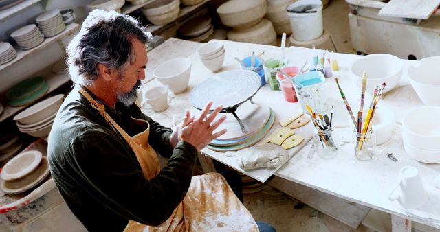 Senior Potter Preparing Clay in Artisan Workshop - Download Free Stock Images Pikwizard.com