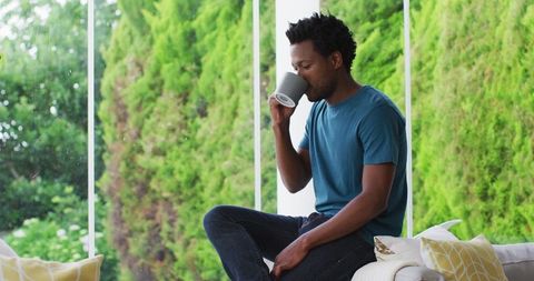 Man Drinking Coffee on Patio Enjoying Serene Morning