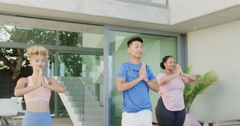 Diverse Group Practicing Yoga Outdoors at Home in Serene Environment