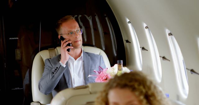 Businessman Talking on Phone in Private Jet - Download Free Stock Images Pikwizard.com