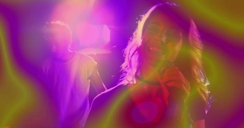 Energetic female singer performing in vibrant concert lights