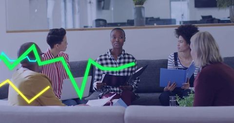 Leading woman holding folder speaking to diverse team in office lounge with neon graph