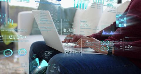 Remote data analyst working on laptop analyzing financial dashboards and trading charts