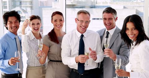 Diverse Business Team Celebrating Success with Champagne in Office
