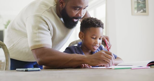 Father Helping Son with Homework at Table - Download Free Stock Images Pikwizard.com