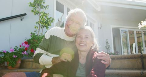 Happy Senior Couple Sitting Together in Sunny Garden