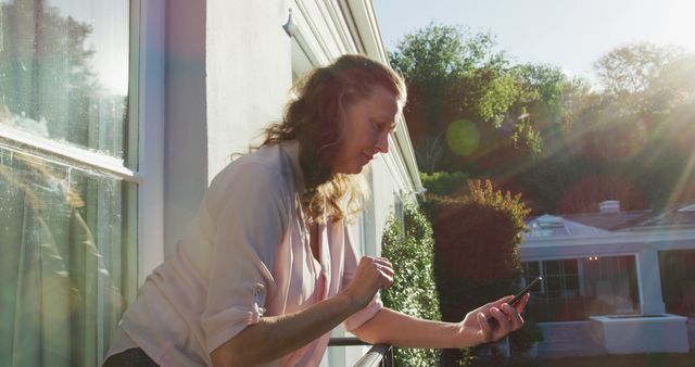 Woman Using Smartphone on Sunny Terrace - Download Free Stock Images Pikwizard.com