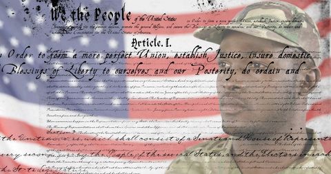 Patriotic soldier saluting with us constitution overlay