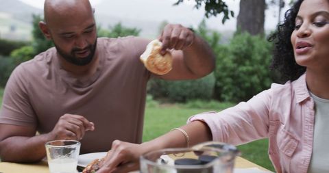 Happy Couple Enjoying Meal Together at Garden Table