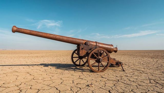 Antique Rusted Cannon on Arid Desert Plain