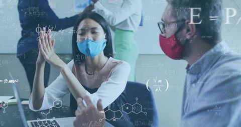 Mask-Wearing Researchers Collaborating on Science Project