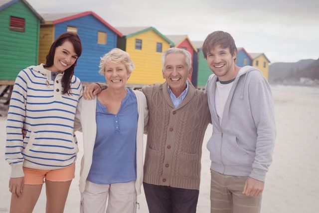 Happy Family Posing at Colorful Beach Huts - Download Free Stock Photos Pikwizard.com