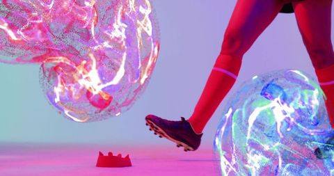 Athlete kicking glowing orbs in futuristic energy display