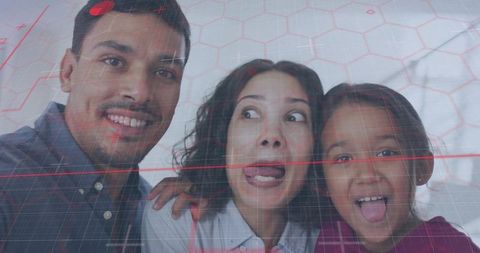 Playful family making faces with augmented reality red grid overlay in cozy home closeup