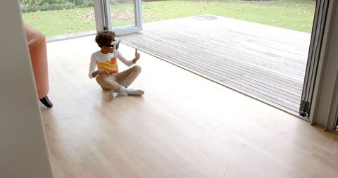 Boy Engaging with Virtual Reality Headset Indoors