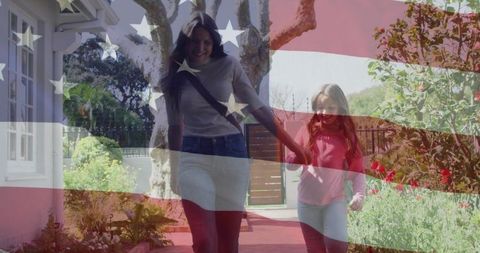 Mother and Daughter Holding Hands on Sunny Garden Path