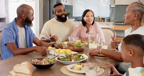 Family Enjoying Delightful Meal Together Around Bright Kitchen Table